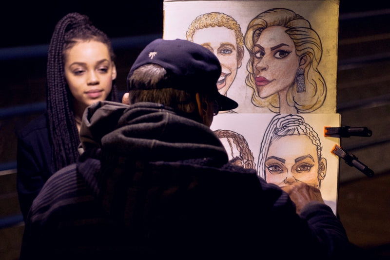 man sketching a woman