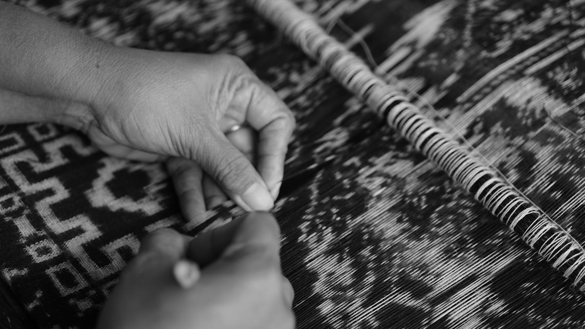 greyscale photography of person stitching textile