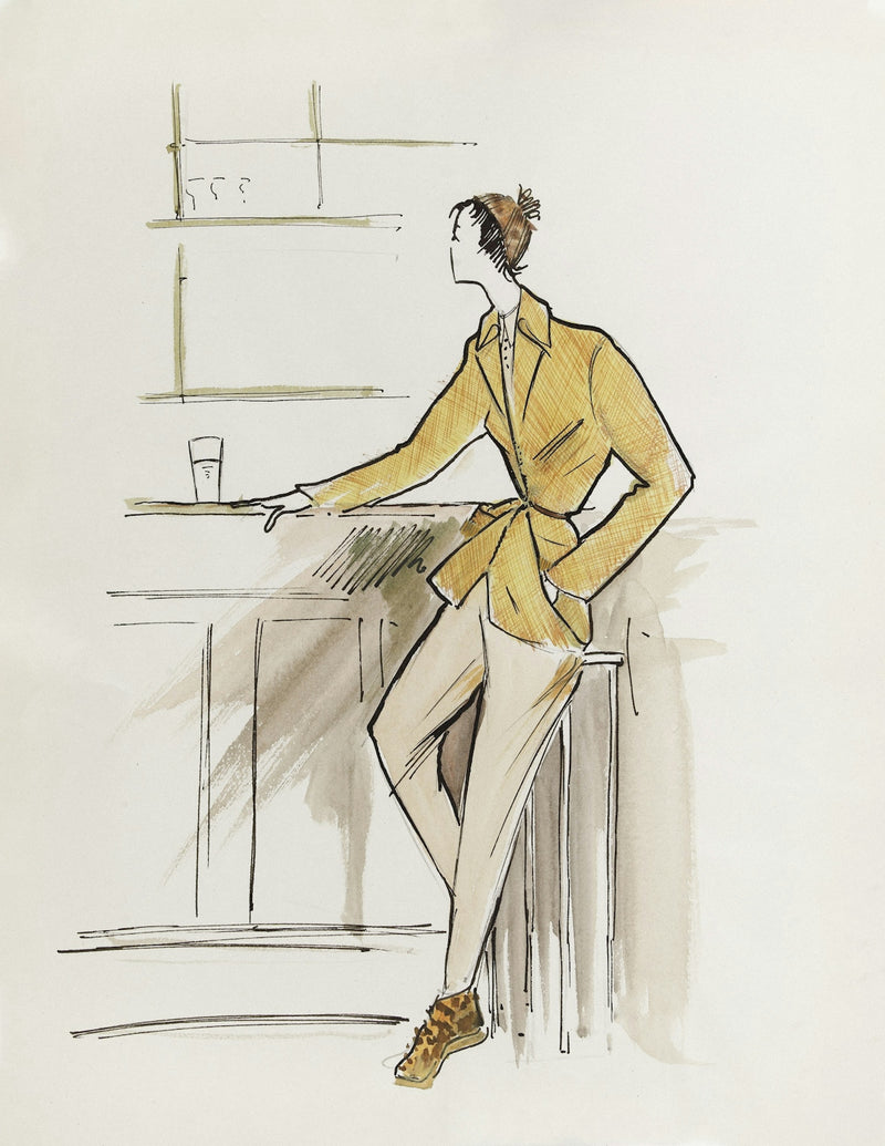Woman in yellow jacket and beige pants at counter
