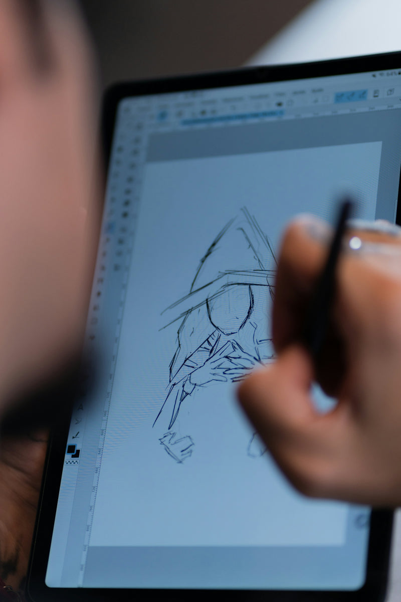 A person drawing on a tablet with a pen