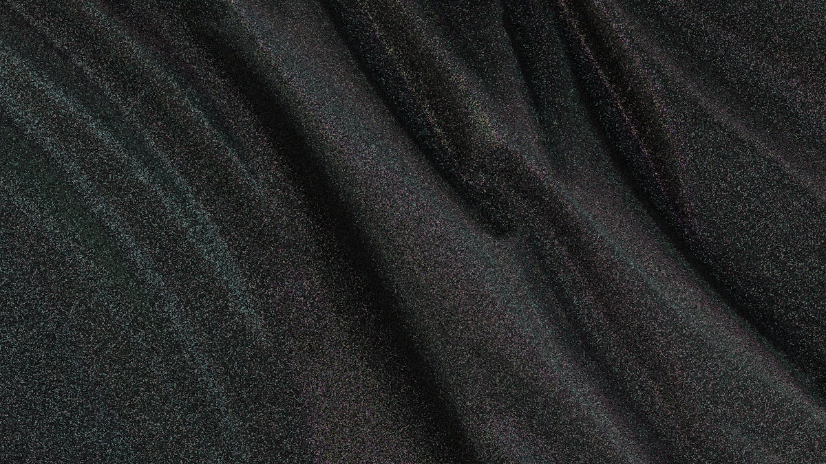 Dark fabric shows creases and waves.