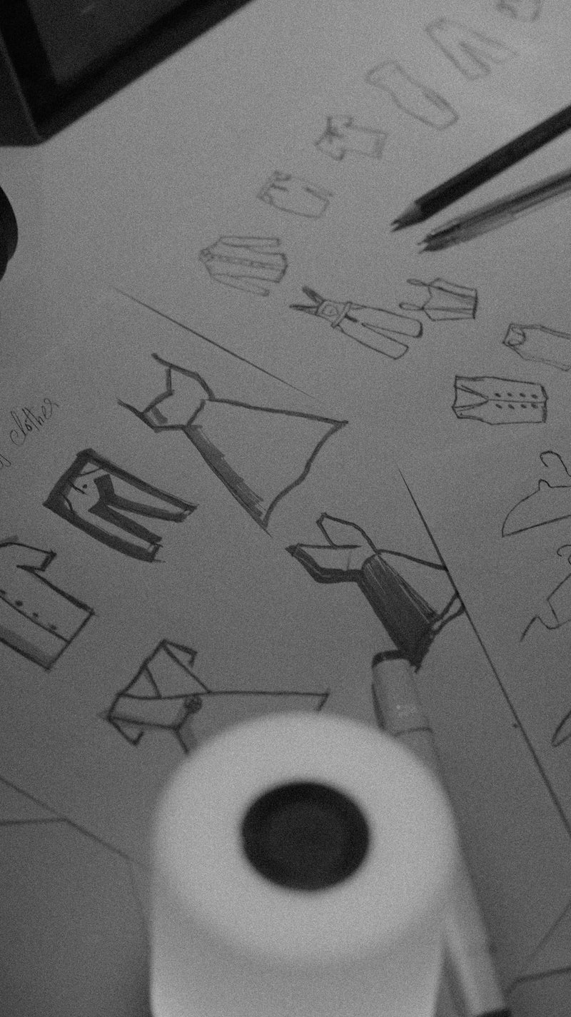 Sketches of clothing designs with pencils and markers.