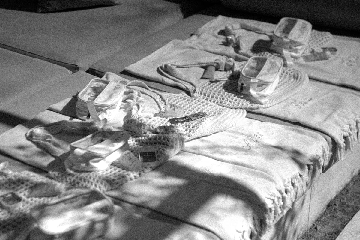 Diapers and baby clothes scattered on beds