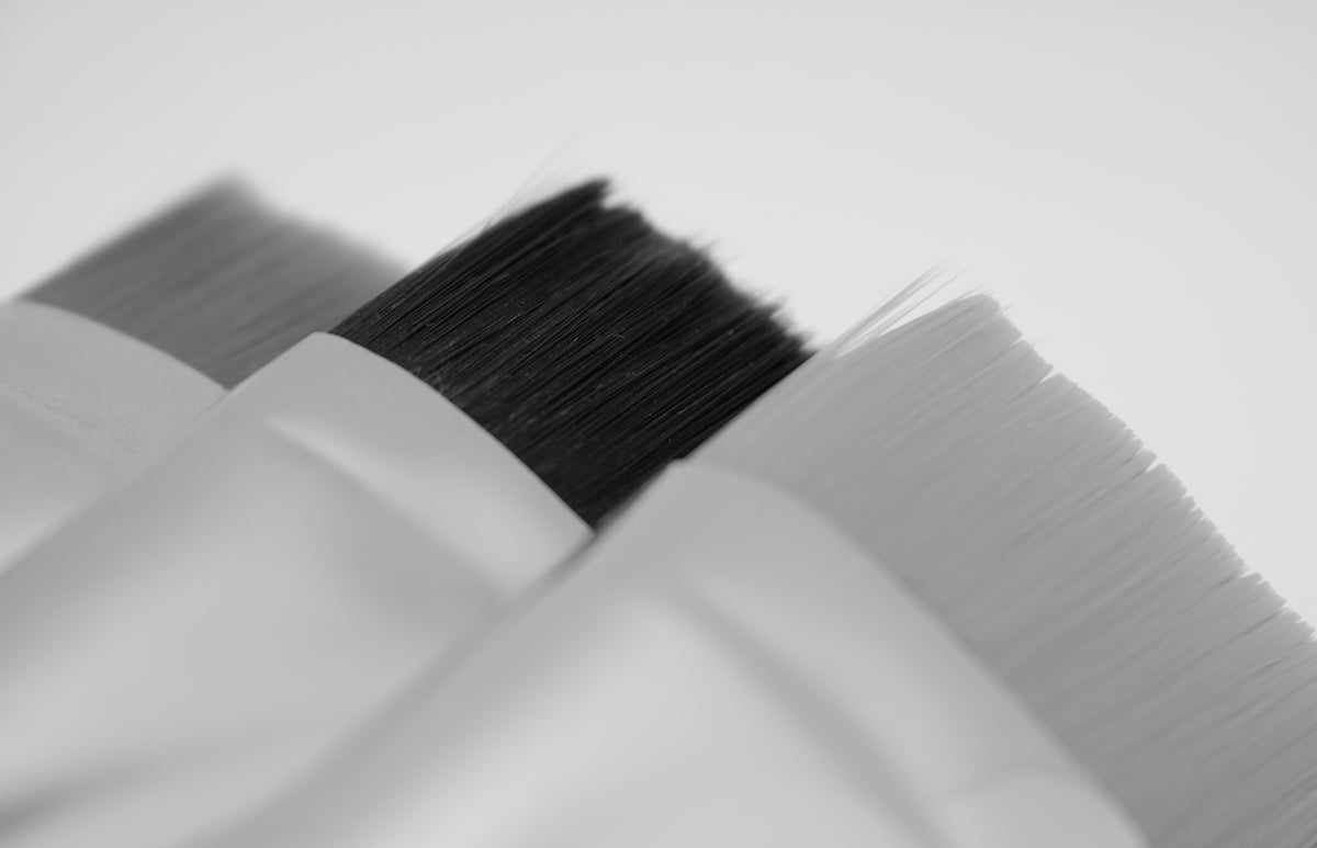 black paint brush on white textile
