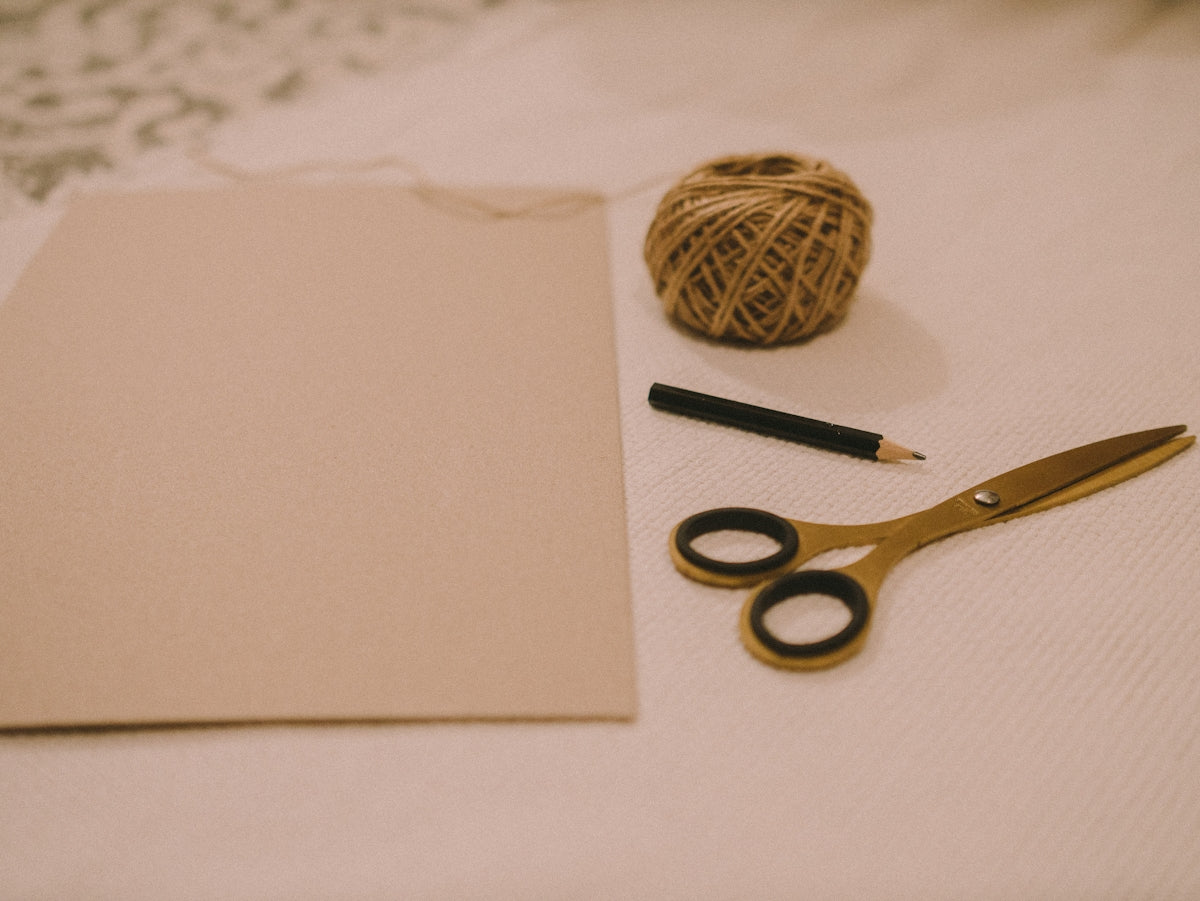 black handled scissors on white printer paper