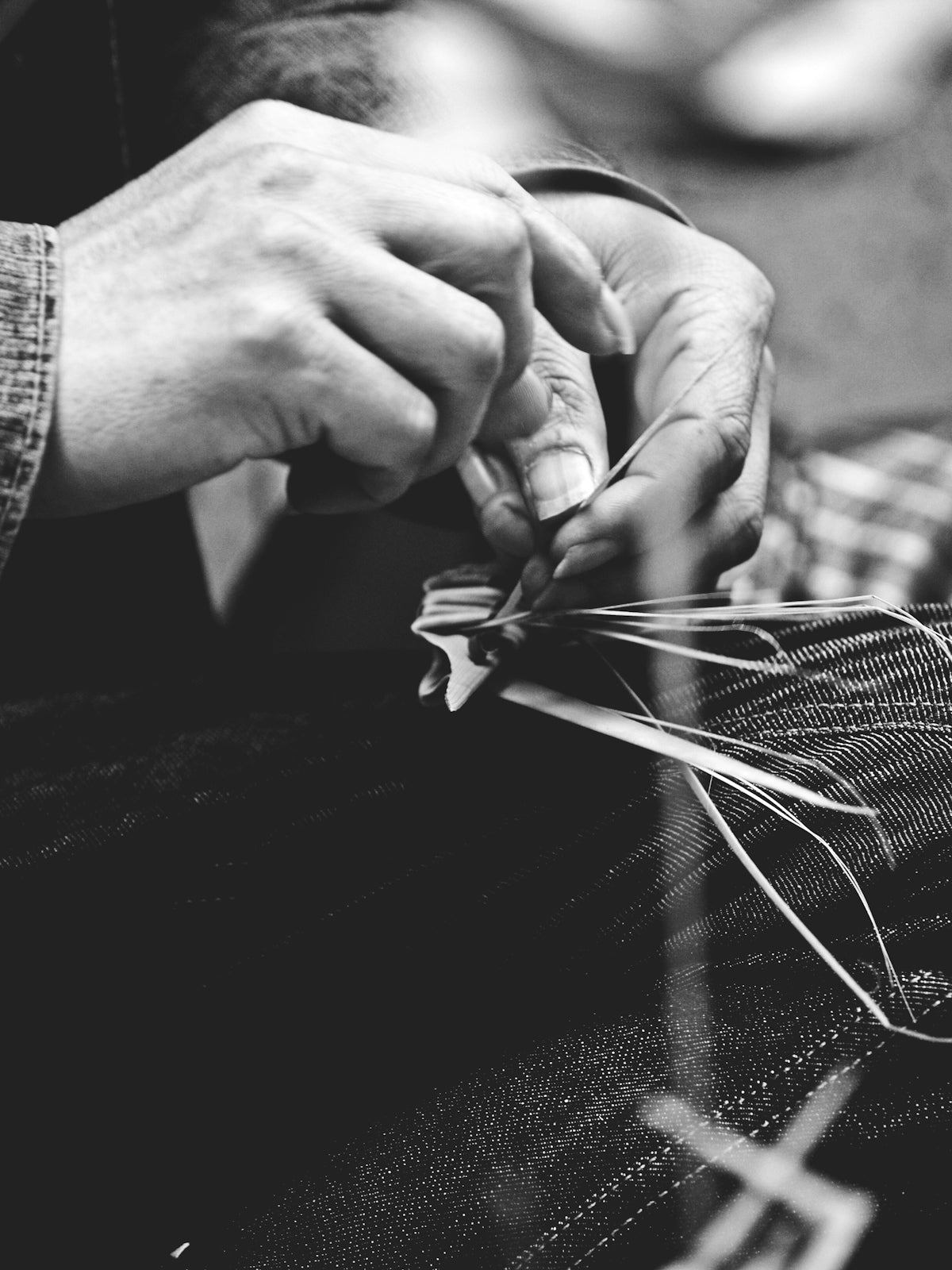 a person cutting fabric with a pair of scissors