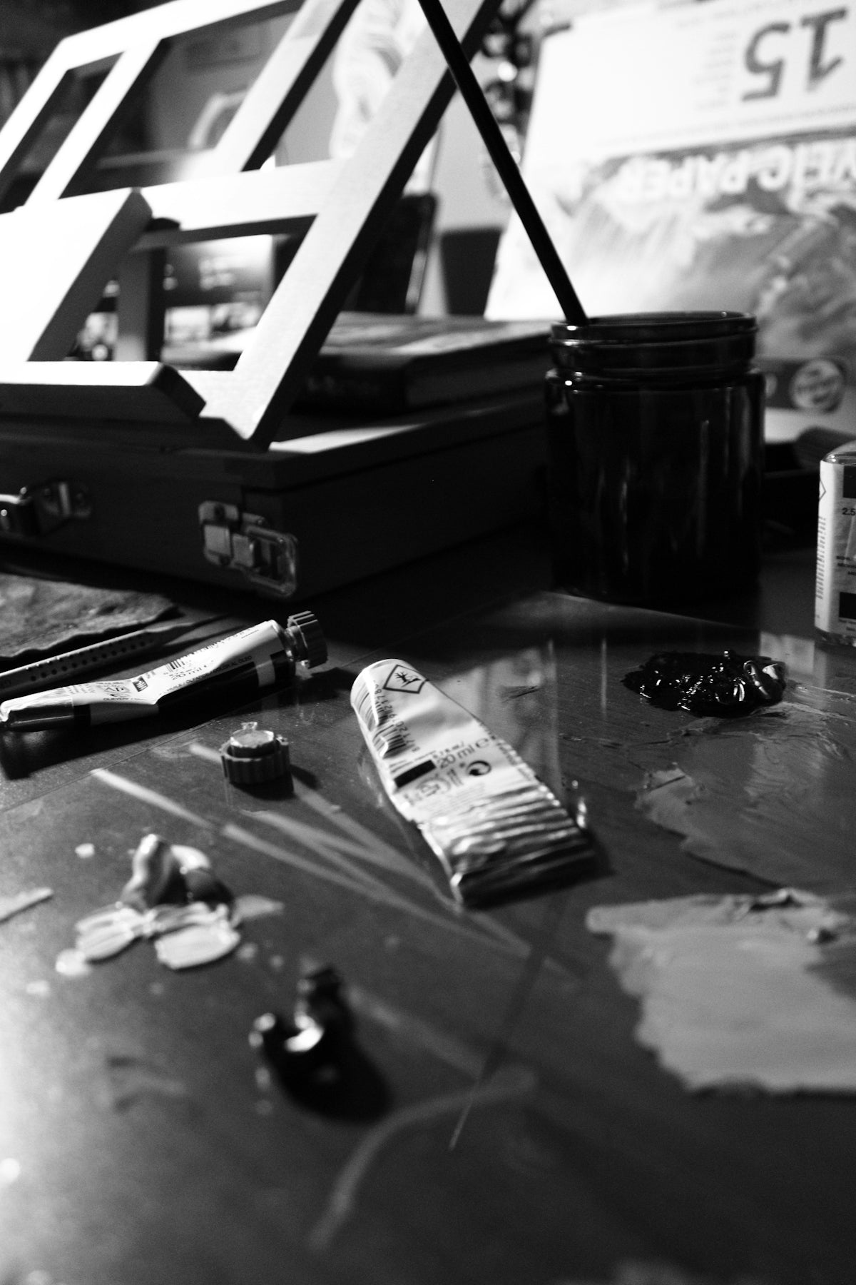 a black and white photo of a messy desk