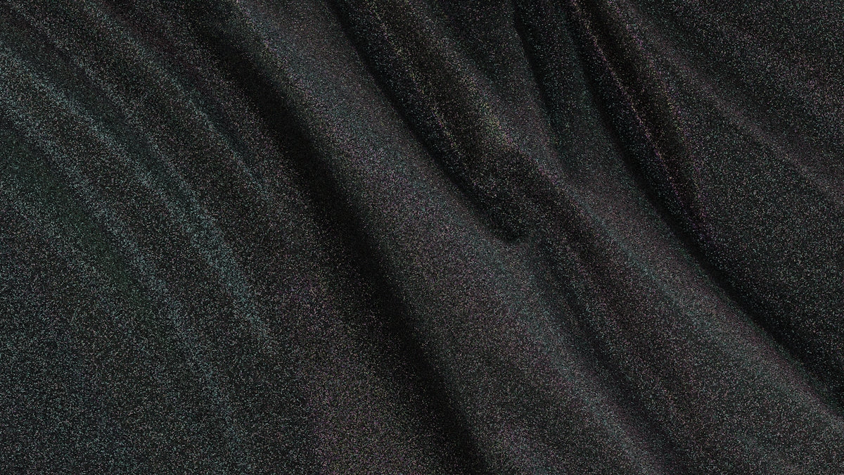 Dark fabric shows creases and waves.